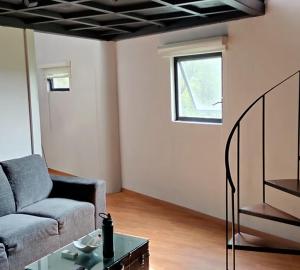 a living room with a couch and a table at CoWork Hotel in Celaya