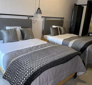 two beds in a room at CoWork Hotel in Celaya