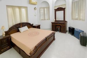 Postel nebo postele na pokoji v ubytování Guruvayur Agraharam Homestay