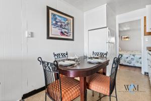 a dining room with a wooden table and chairs at 2 Bed1 Bath on the Boardwalk by the Inlet in Ocean City