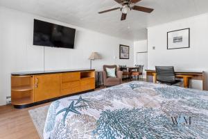 a bedroom with a large bed and a flat screen tv at 2 Bed1 Bath on the Boardwalk by the Inlet in Ocean City