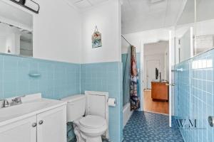 a blue and white bathroom with a toilet and a sink at 2 Bed1 Bath on the Boardwalk by the Inlet in Ocean City +26 photos