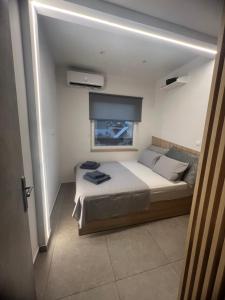 a bedroom with a large bed with a window at Madi apartment in Veria