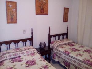 Posteľ alebo postele v izbe v ubytovaní Hostal Muriel