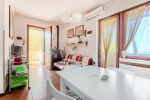 a living room with a white table and a couch at Casa Lola - Goelba in Capoliveri