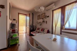 a living room with a table and a couch at Casa Lola - Goelba in Capoliveri +7 photos