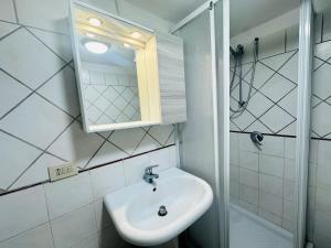 a bathroom with a sink and a mirror and a shower at Dragonara in Ponza