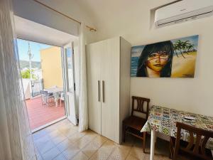 a dining room with a table and a painting on the wall at Dragonara in Ponza