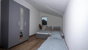a living room with two beds and a mirror at Black Forest Apartment in Friesenheim