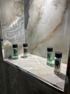 a shelf with three coffee cups on it at Zhiti Waves in Durrës +88 photos