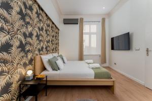 a bedroom with a bed and a wall mural at Old Town Luxe Retreat - King Bed - Steps to Main Square in Kraków