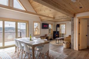 a dining room and living room with a table and chairs at Arrow Head Cabin in Killington