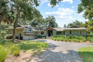 a house with a tree and a driveway at 151 Augusta National Court by Akers Ellis Rentals in Kiawah Island