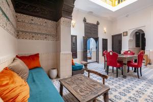 a living room with a couch and a table at Riad GUENAOUA Jacuzzi & Rooftop in Marrakesh