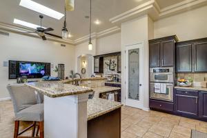 a large kitchen with wooden cabinets and a counter top at Family-Friendly El Paso Home Hike, Shop and Explore in Santa Teresa