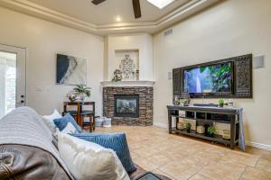 a living room with a couch and a flat screen tv at Family-Friendly El Paso Home Hike, Shop and Explore in Santa Teresa