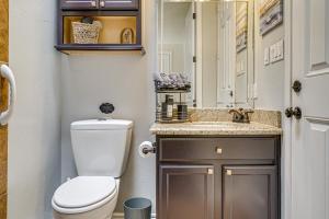 a bathroom with a toilet and a sink and a mirror at Family-Friendly El Paso Home Hike, Shop and Explore in Santa Teresa +21 photos