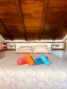 three pillows sitting on top of a bed at Cozy apartment & amazing views Albayzín in Granada