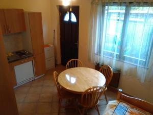 a kitchen and dining room with a table and chairs at Apartment Jasmine in Izola