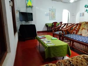 a living room with a green table and chairs at Green Villa in Nuwara Eliya