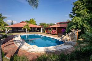 a swimming pool in front of a house at Casa Ambito in San Raymundo Jalpan
