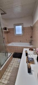a bathroom with a shower and a tub and a sink at The Cottages - Pet Friendly in Meißendorf +59 photos