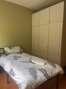 a bedroom with a bed with a white comforter at Countryside Family Home in Balrath