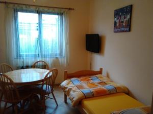 a room with a table and a bed and a window at Apartment Jasmine in Izola