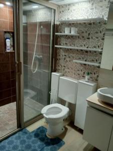 a bathroom with a toilet and a shower and a sink at Golden Horn Apartment in Agadir +65 photos