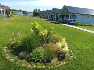 a yard with a house and a playground at Domki Martes Wicie in Wicie +78 photos