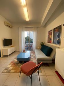 a living room with a couch and a table at The Blue - Svolio Hospitality in Komotini
