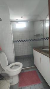 a bathroom with a toilet and a shower and a sink at Apartamento pé na areia - João Pessoa -Paraíba in João Pessoa