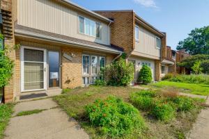 a house with a garden in front of it at 3 Mi to Dulles Airport D C Area Townhome in Herndon