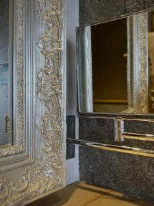 a gold door with a mirror on the side of it at Hotel La Crémaillère in Le Grand-Bornand