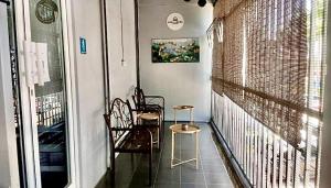 a room with two chairs and a table on a balcony at Ozzy Lodge Semporna in Semporna +28 photos
