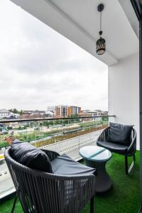 a balcony with chairs and a table and a view at Casa Aurelia Penthouse in Lekki