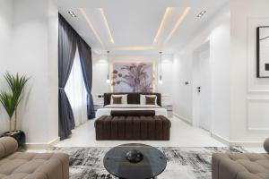 a bedroom with a bed and a couch at Casa Aurelia Penthouse in Lekki