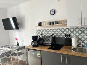 a kitchen with a sink and a counter top at Apartament 44A Dębina I 400 m do plażyl przyjazny rowerzystom in Debina