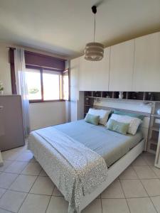 a bedroom with a large bed in a room at Casa di Stefy in Quartu SantʼElena