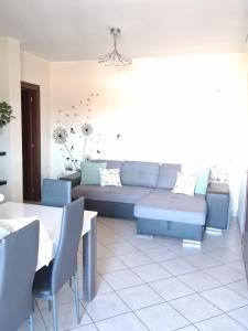 a living room with a couch and a table at Casa di Stefy in Quartu SantʼElena