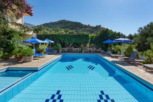 a swimming pool with blue tiles in a resort at Sunrise Hotel & Apartments in Rodakino