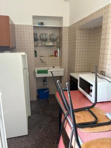 a kitchen with a table with a microwave on it at Loft Incantevole in Peschici