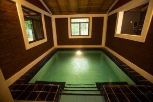 a swimming pool in a room with a room with at Funk Bunks - Sigiriya in Sigiriya