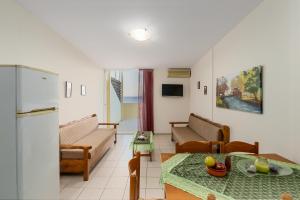 a living room with a couch and a table at Sunrise Hotel & Apartments in Rodakino