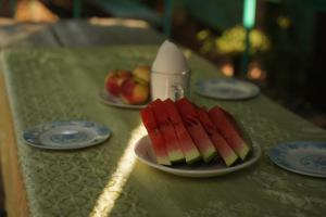 a plate of slices of watermelon on a table at Alpinist Homestay in Arslanbob