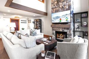 a living room with white furniture and a stone fireplace at KBM Resorts Upgraded Easy walk to Main St Close to Deer Valley hot tub gas fireplace BCC-1101 in Park City