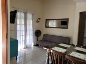 a living room with a table and a couch at Chalé no Caborê in Paraty