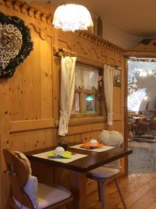 a kitchen with a table and chairs in a room at CERMIS Minisuite in Cavalese +16 photos