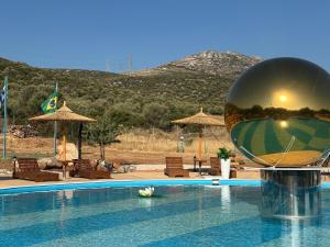 a pool with a large ball on top of it at Seven stars Camping Evelina in Keratea