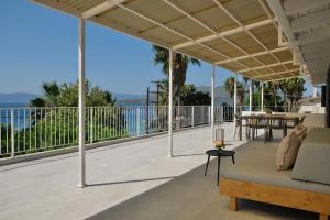 an outdoor patio with a couch and a table at Evia Bay Suites and Retreats in Edipsos